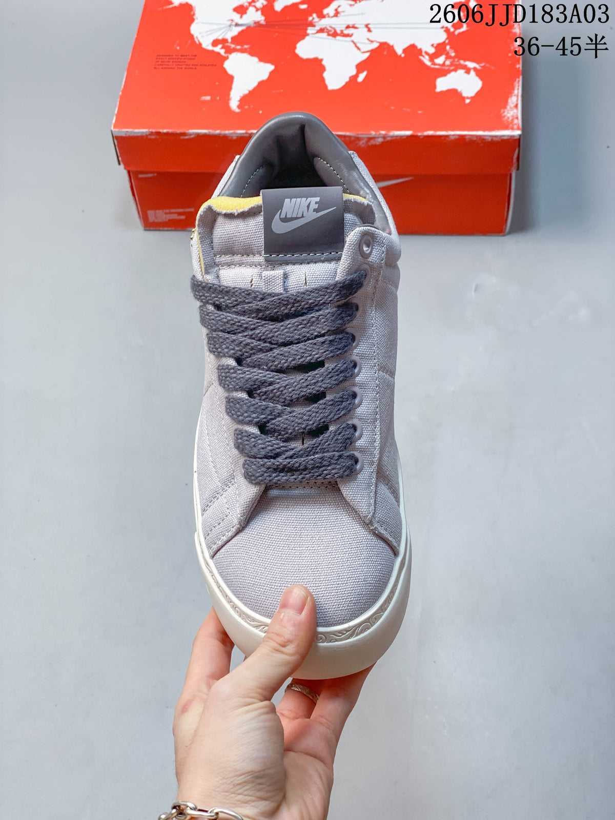 Front view of a gray Nike Blazer sneaker with dark laces and a Nike tongue label