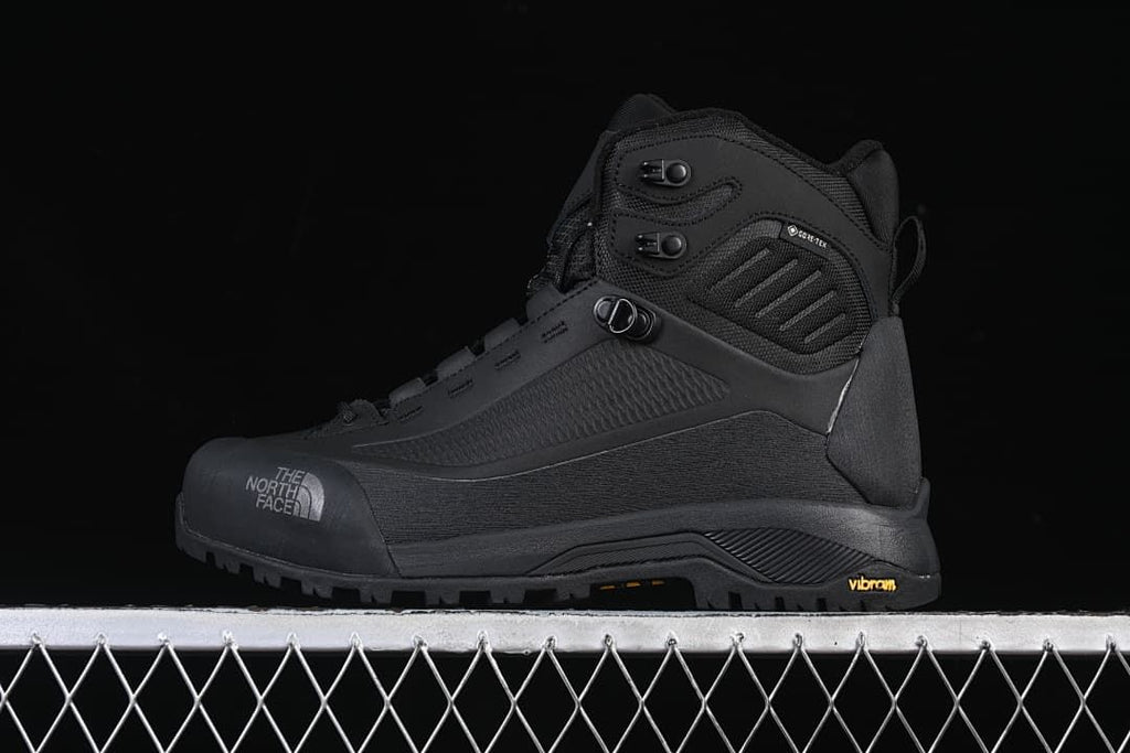 Side view of a black The North Face Verto Alpine Mid boot.