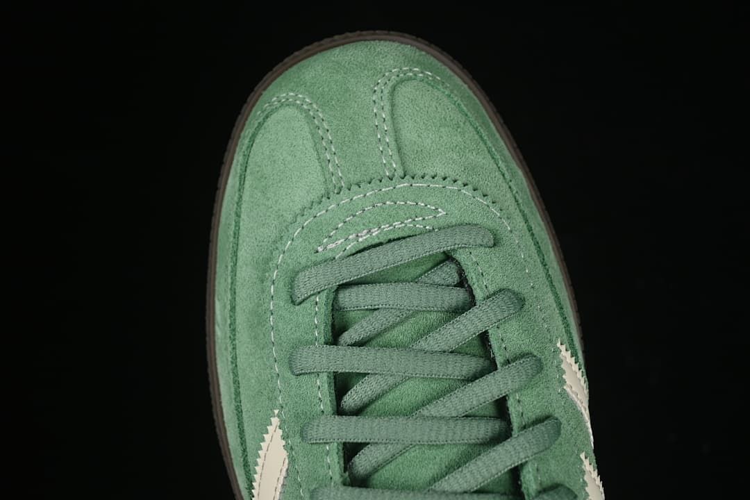 Top view of the green sneaker's toe and lacing