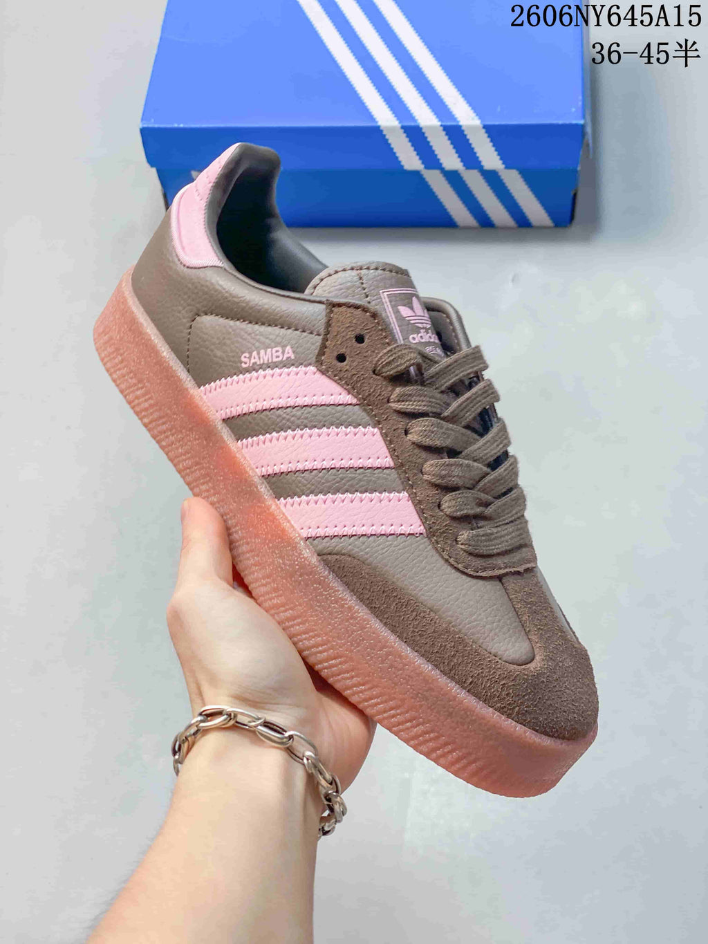 Close-up of a brown Adidas Sambae sneaker with pink side stripes and a raised gum-look sole.