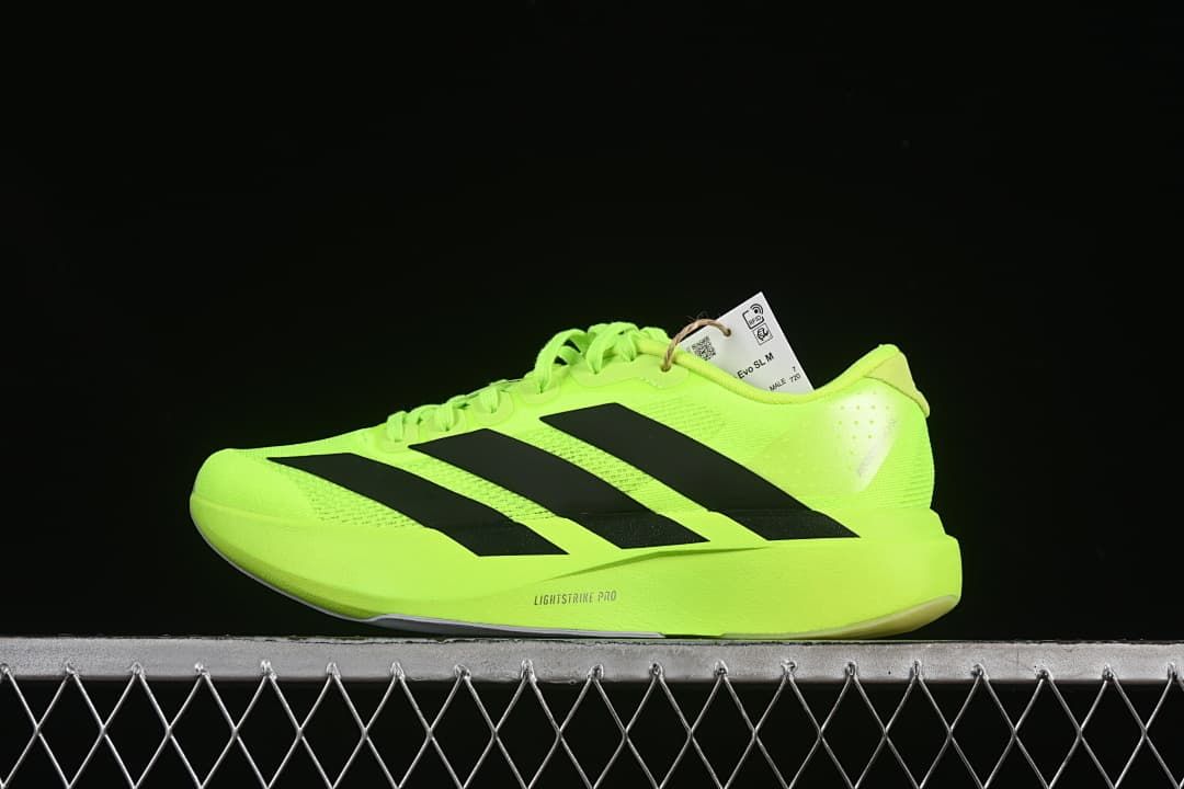 Side view of neon yellow Adidas Adizero Evo SL running shoe with black stripes.