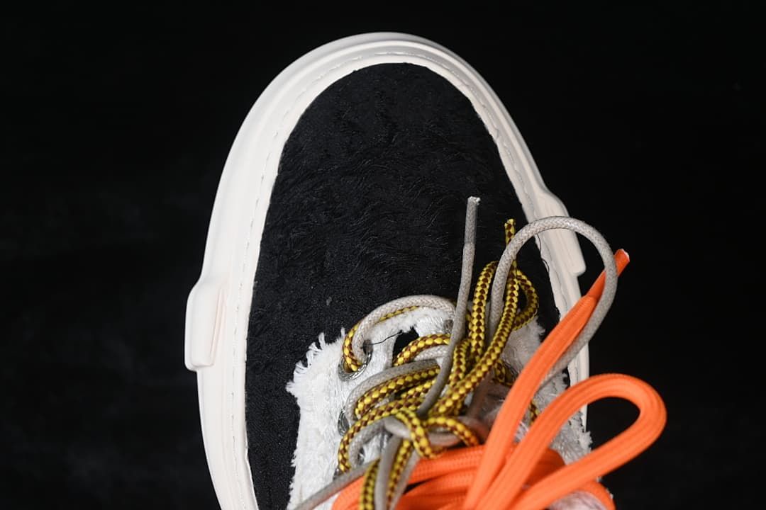 Top view of the black toe panel and multicolor laces