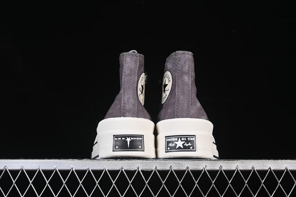 Rear view of both shoes showing heel labels and layered soles.