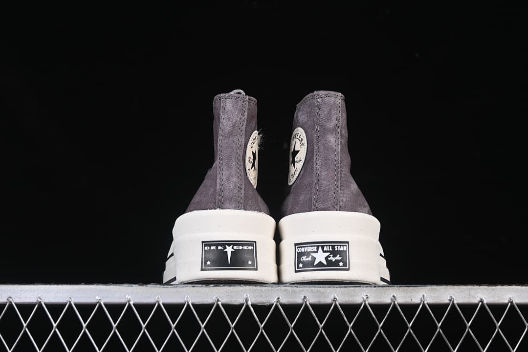 Rear view of both shoes showing heel labels and layered soles.