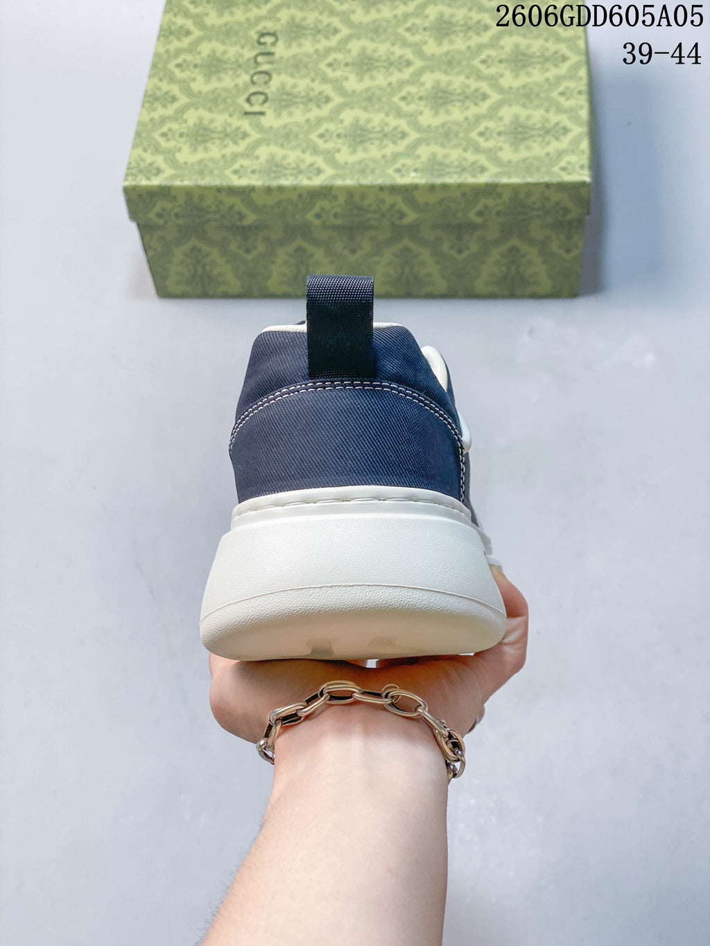 Rear view showing the navy heel, pull tab, and thick white sole