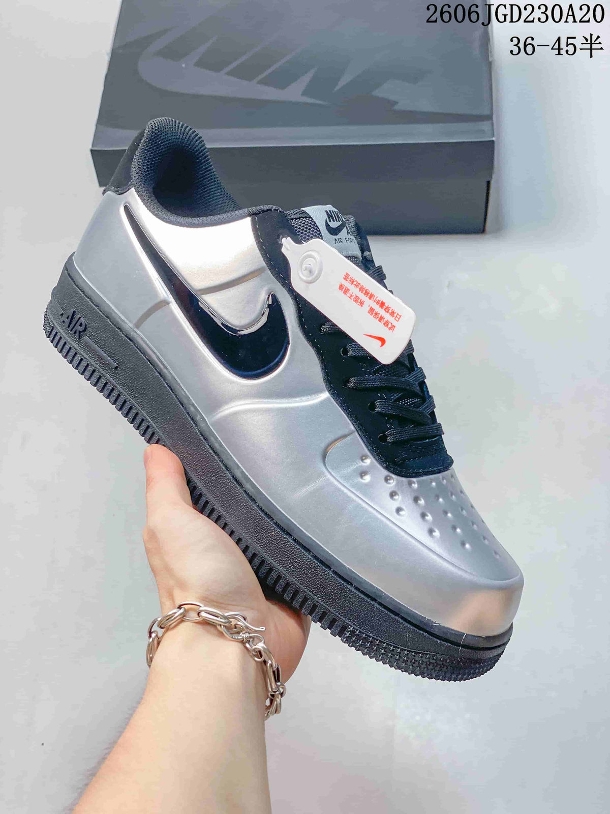 Close-up of a silver and dark navy low-top sneaker with a dark side Swoosh