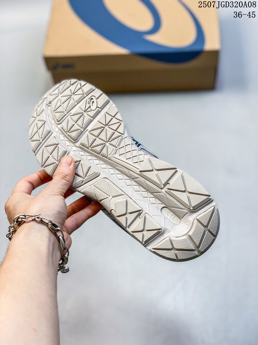 Close-up of the patterned outsole on the gray running shoe