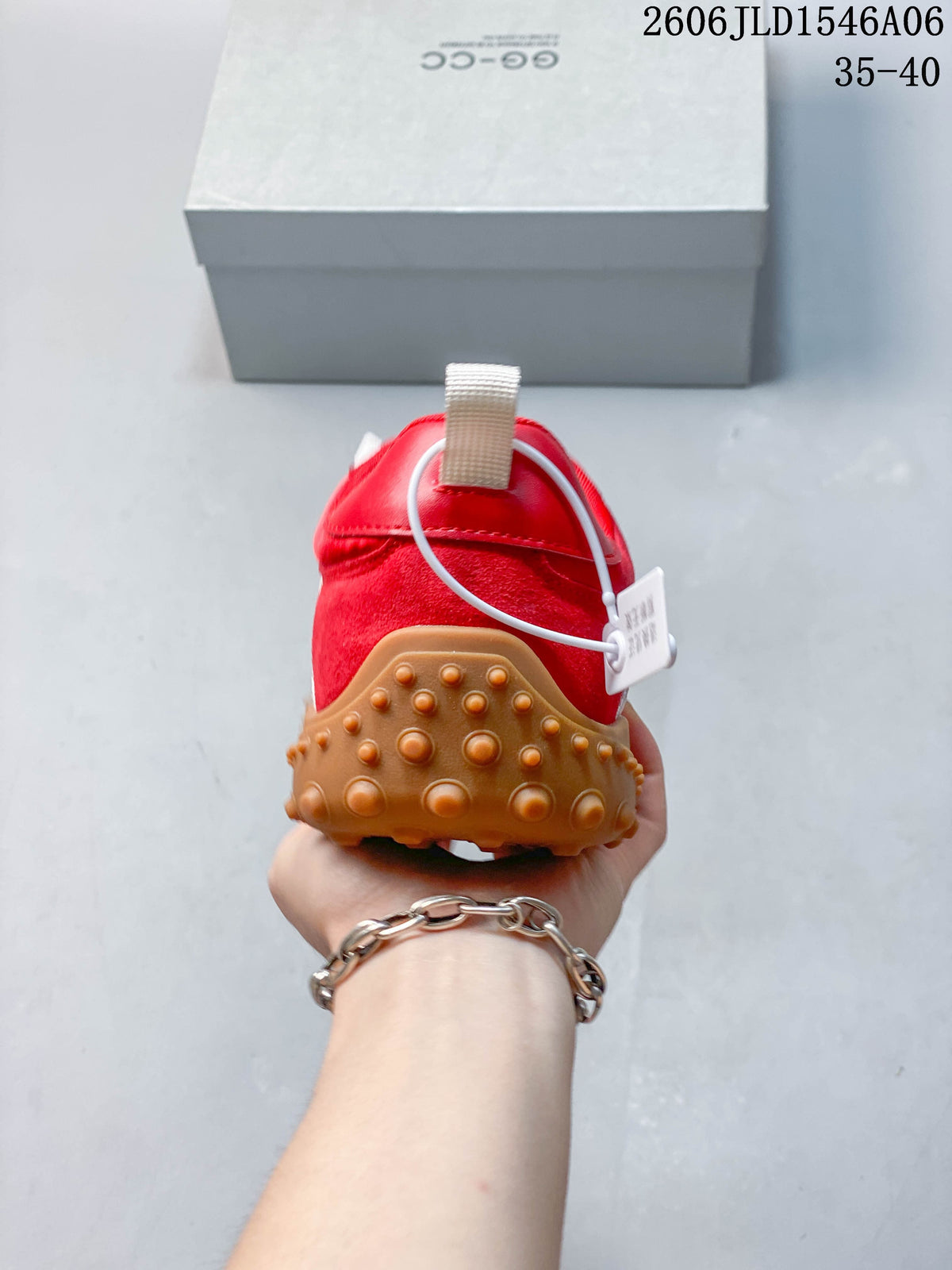 Rear view showing the red heel and raised gum-colored outsole.