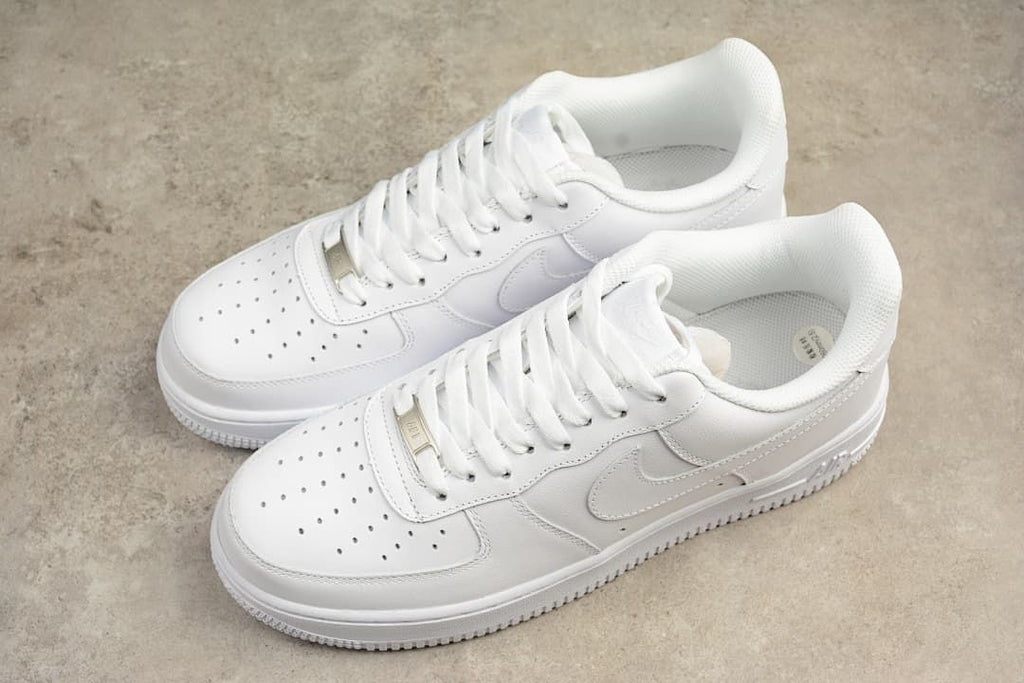 Pair of white low-top sneakers shown from an angled top view.
