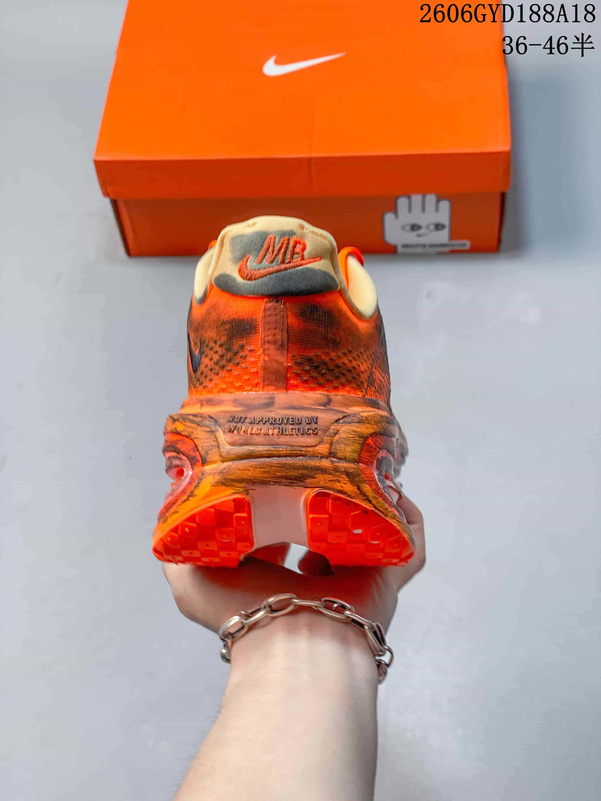 Rear view of an orange Nike Air Pegasus Premium sneaker showing the heel and sole.