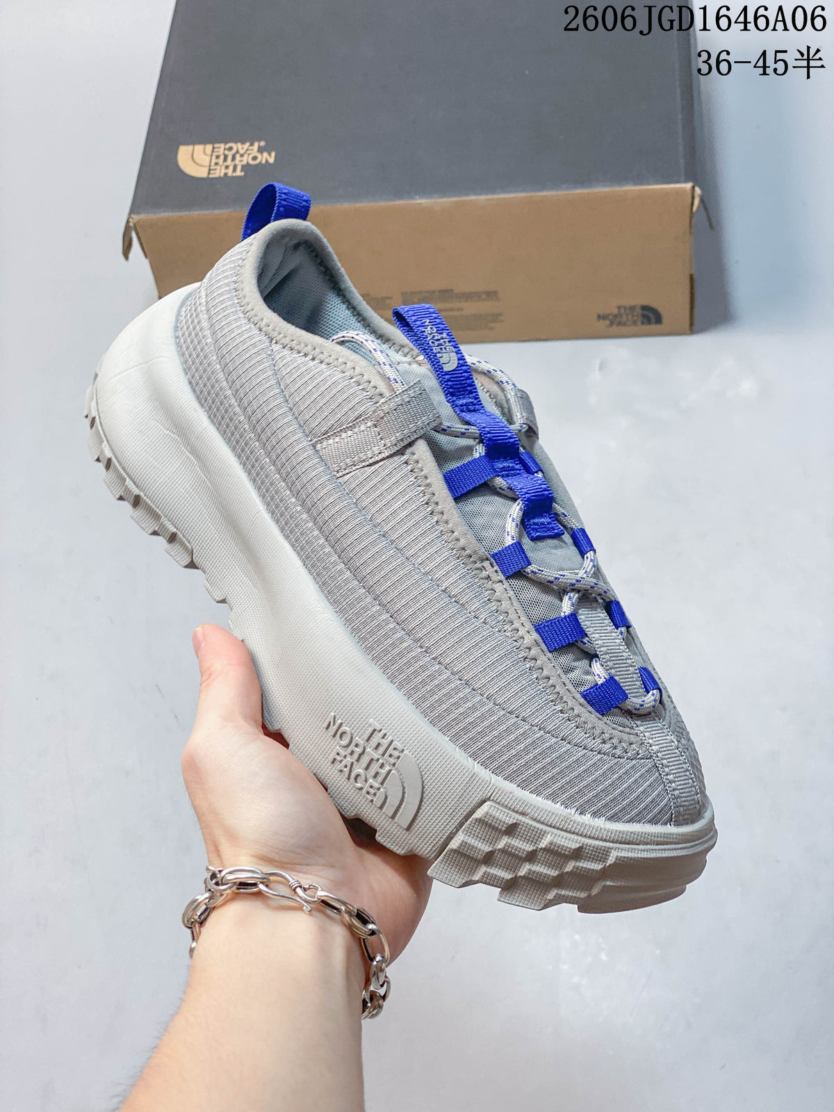 Angled side view of the gray mule shoe with blue accents.