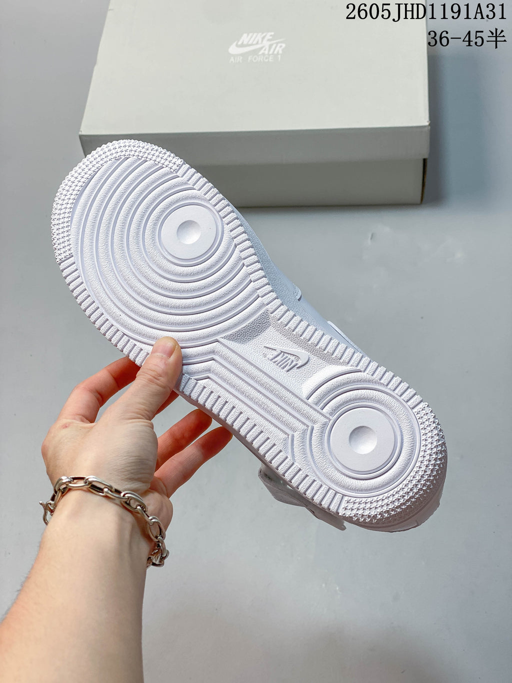 Close-up of the white sneaker's circular-patterned outsole