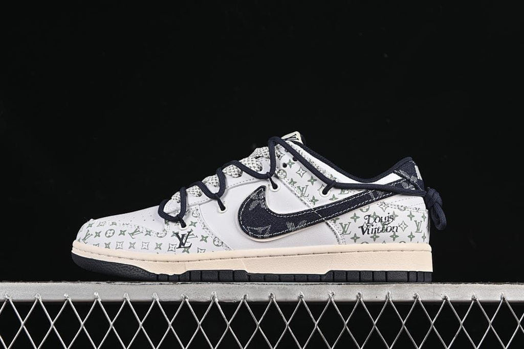 Side profile of a low-top Nike SB Dunk sneaker with white patterned panels and a dark navy Swoosh.