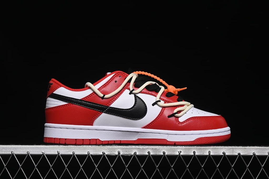 Side profile of a low-top sneaker with red, white, and black panels