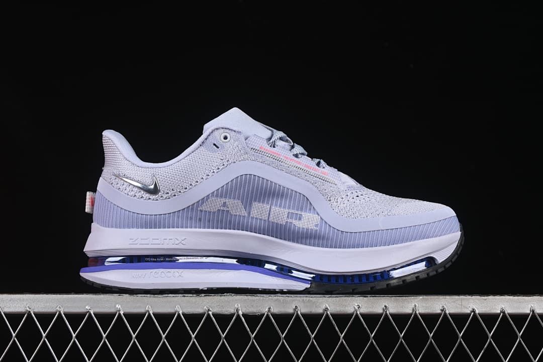 Side profile showing the gray and lavender upper and visible blue-toned midsole