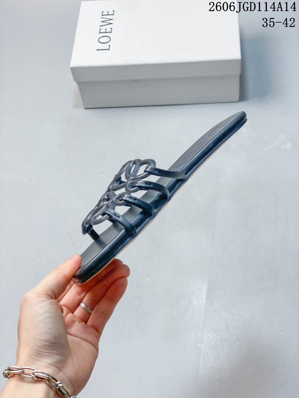 Rear view of the flat sole and open-back construction of a dark navy slide sandal.