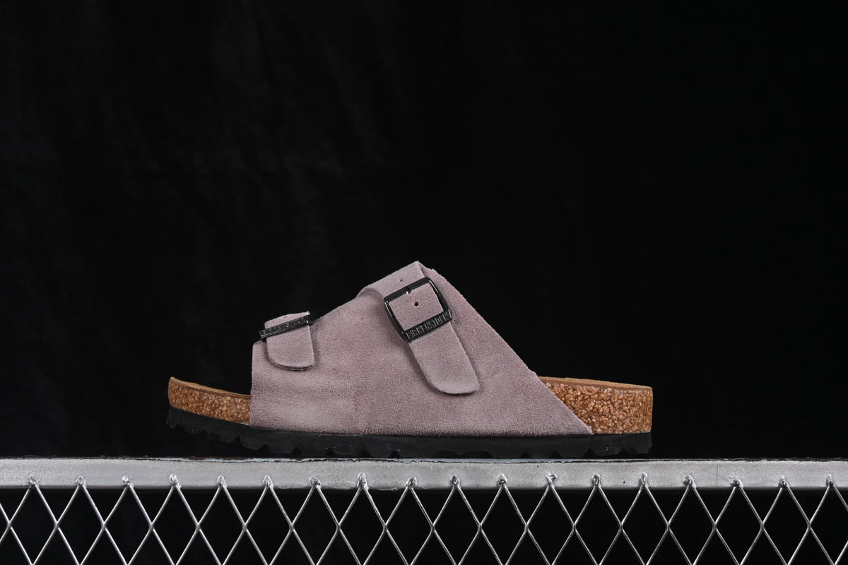 Side profile of a lavender two-strap sandal with a contoured footbed and black outsole.