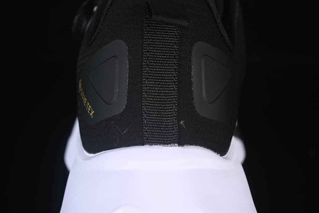 Rear view highlighting the heel pull tab and white midsole.