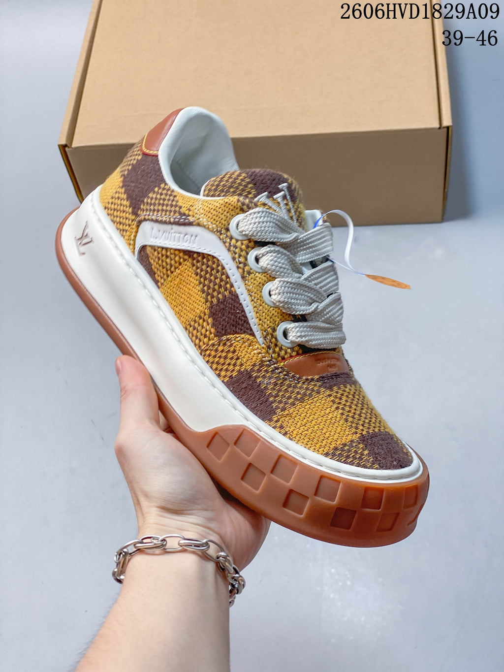 Angled side view of checkerboard sneaker with white side detailing and brown outsole