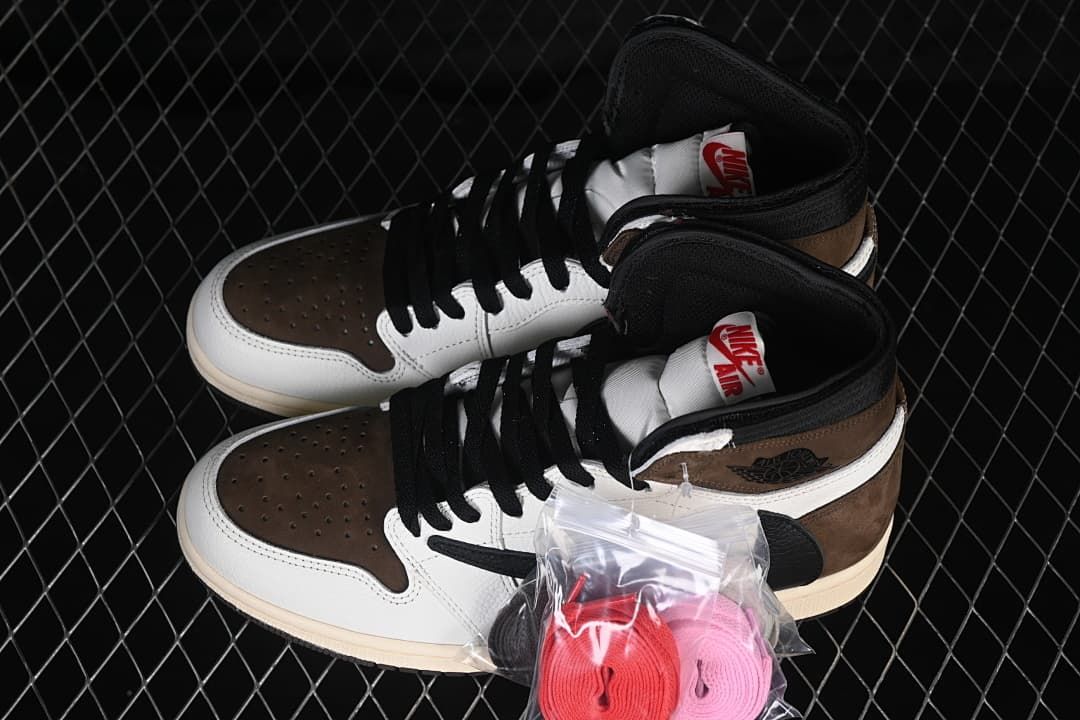 Pair of brown, white, and black high-top sneakers with extra laces
