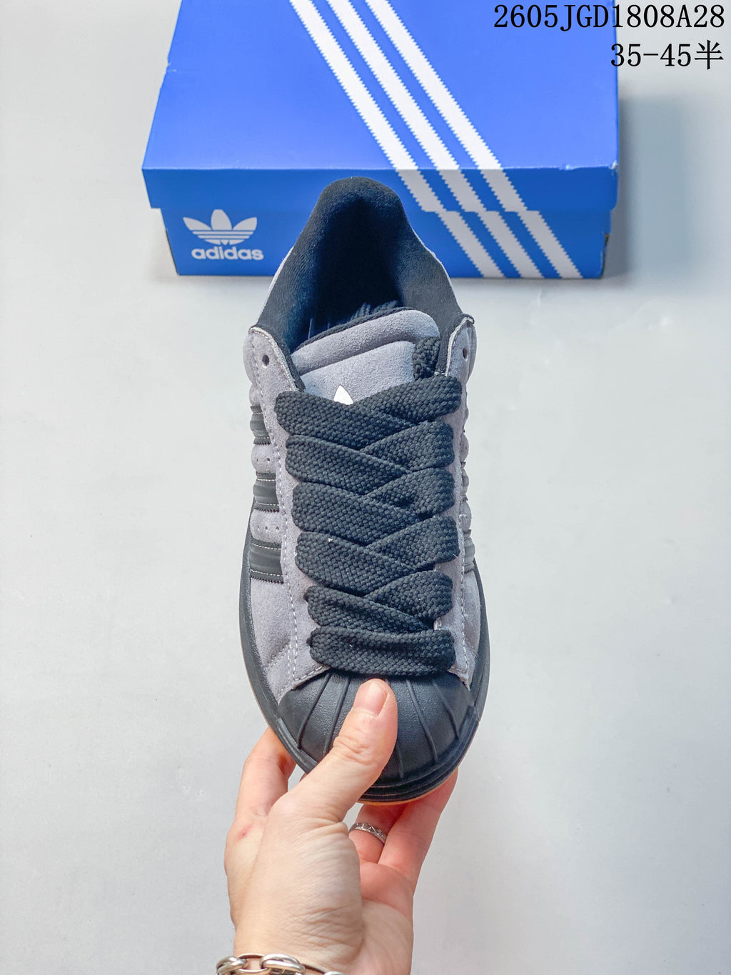 Front view highlighting the dark shell toe and laces on the grey shoe.