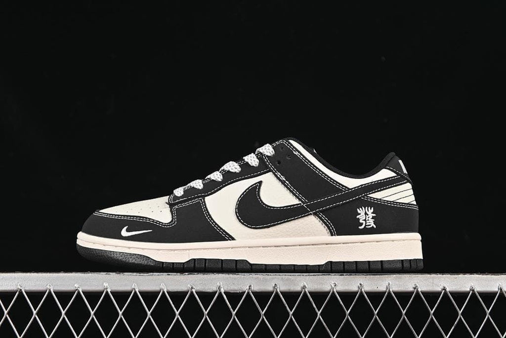 Side view of a black and off-white low-top sneaker with contrasting panels and a heel character graphic