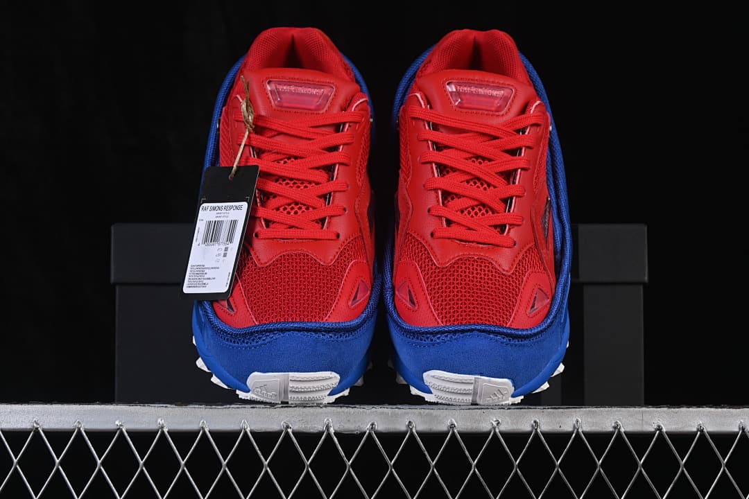 Front view of red and blue adidas Raf Simons Response Trail sneakers