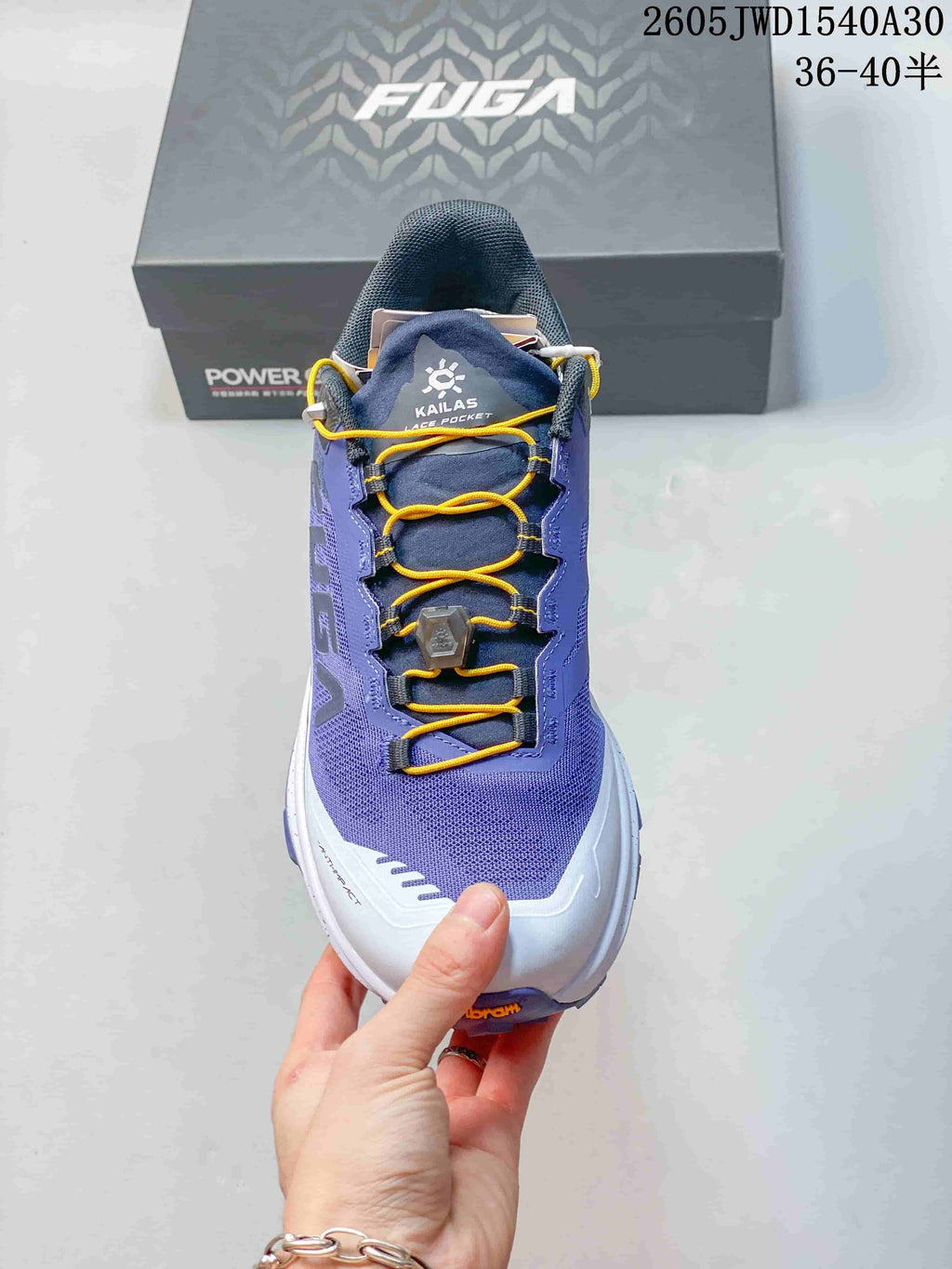 Front view showing the mesh upper, yellow laces, and adjustment dial.