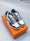 Pair of white and navy low-top sneakers shown on an orange box