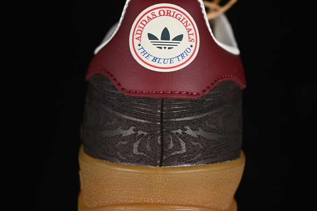 Rear close-up of the burgundy heel tab and patterned dark heel panel.