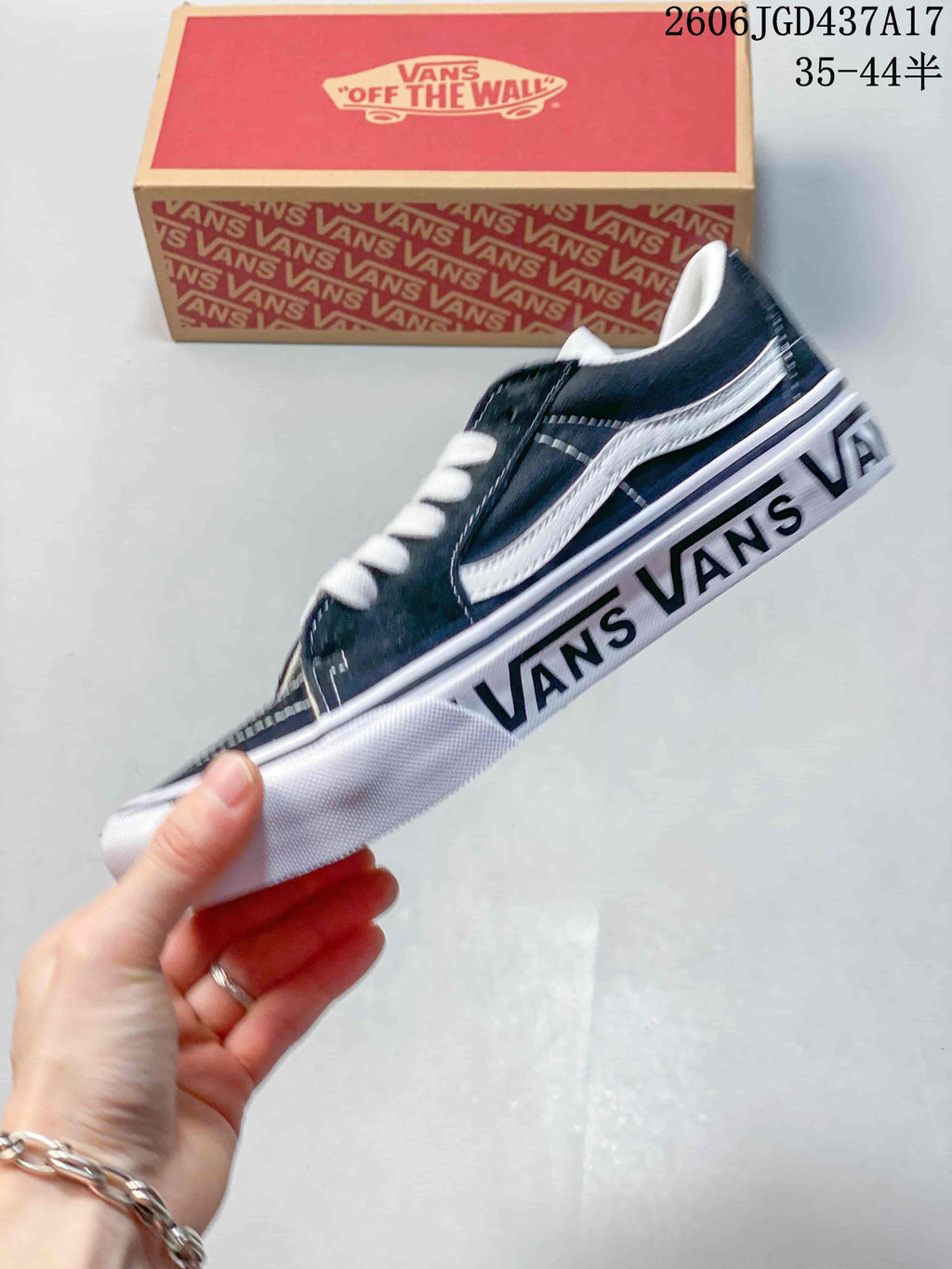 Side view showing the white stripe and Vans lettering along the sole