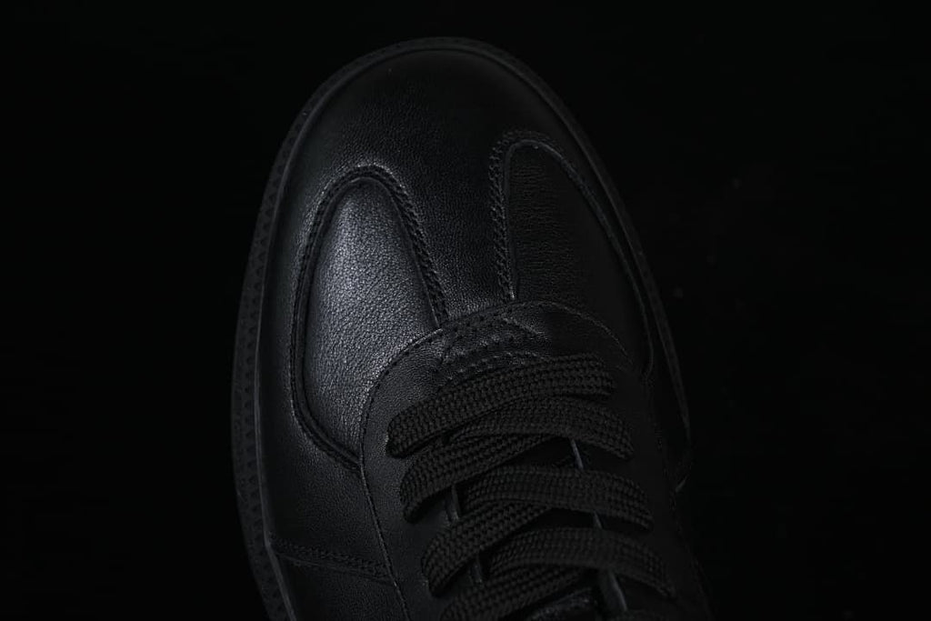 Top-down close-up of the black sneaker toe and laces