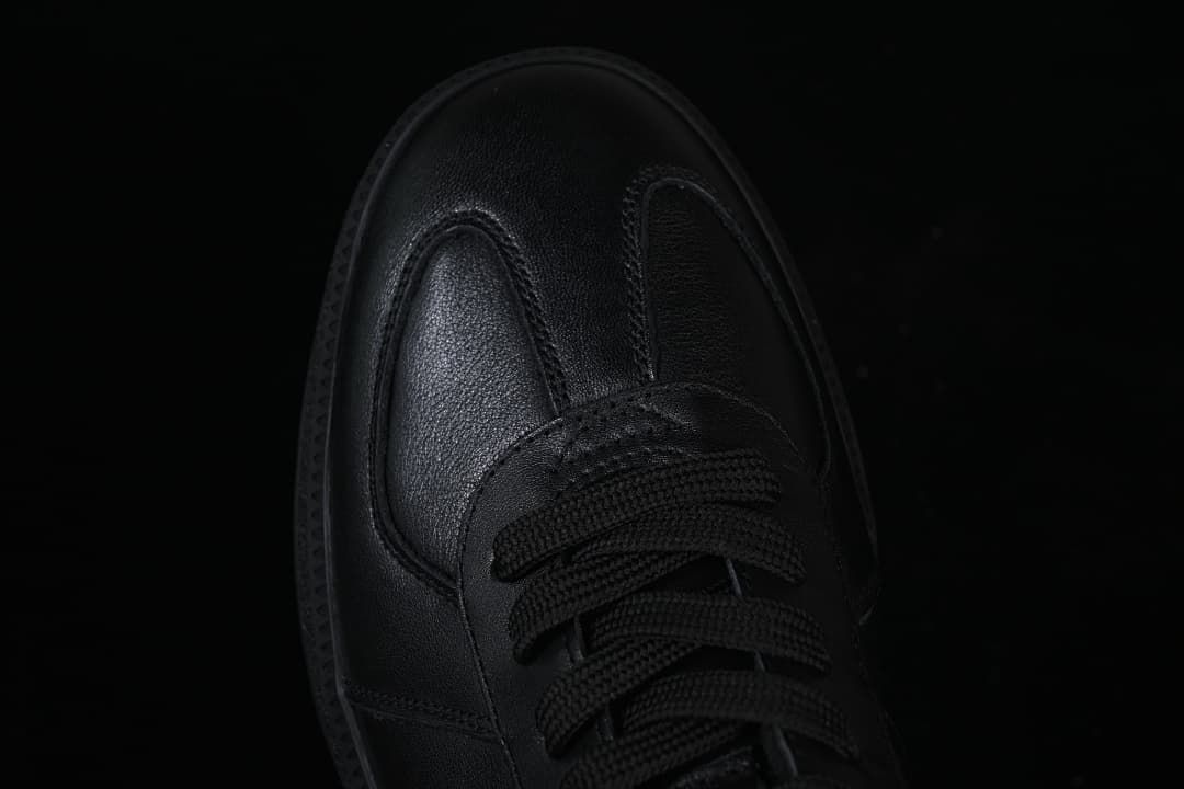 Top-down close-up of the black sneaker toe and laces