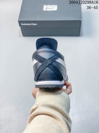Rear view of the navy and white ASICS Tiger Mexico 66 sneaker with the branded box behind it.