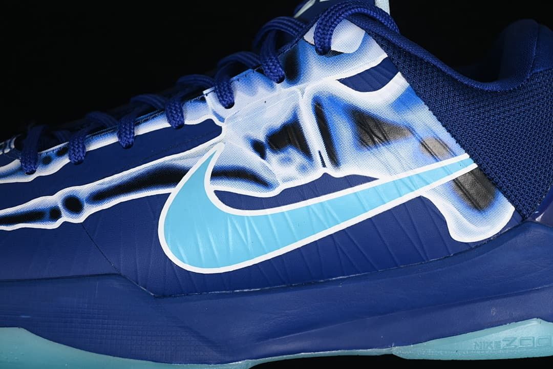 Close-up of blue upper, aqua Swoosh, and skeleton-inspired graphic