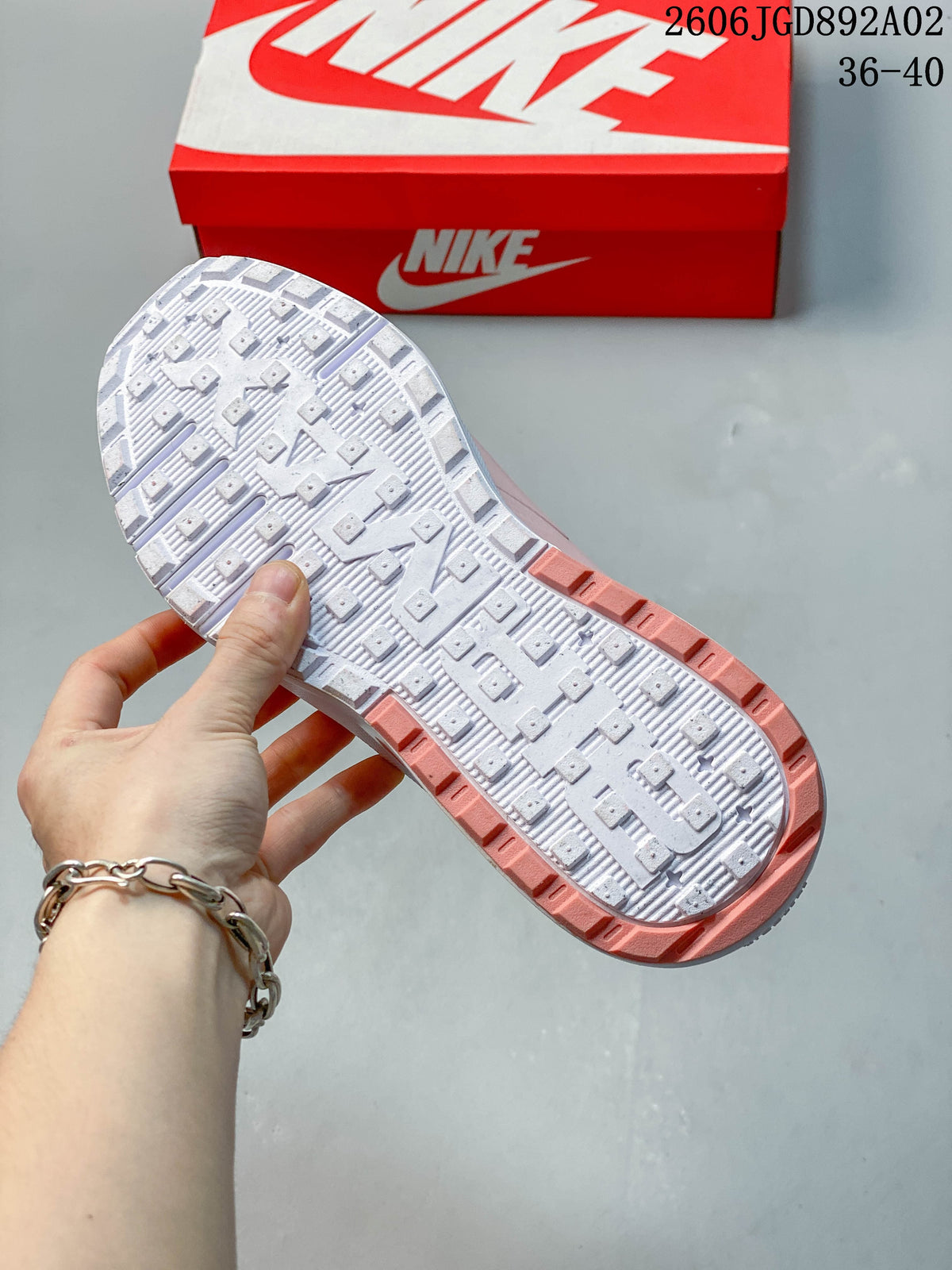Close-up of the white outsole and pink edge accents