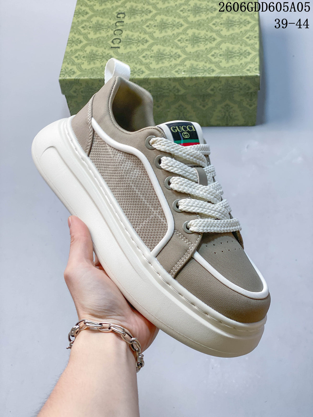 Side view of a beige lace-up sneaker showing textured panels, contrast piping and a thick white sole.