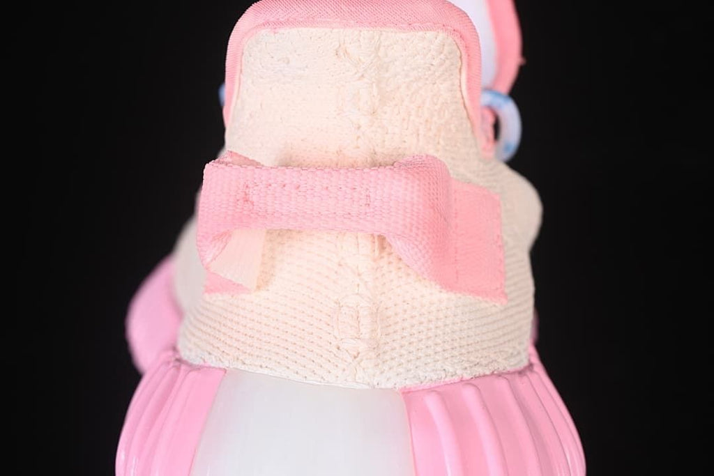 Rear view highlighting the pink heel tab and ribbed sole.