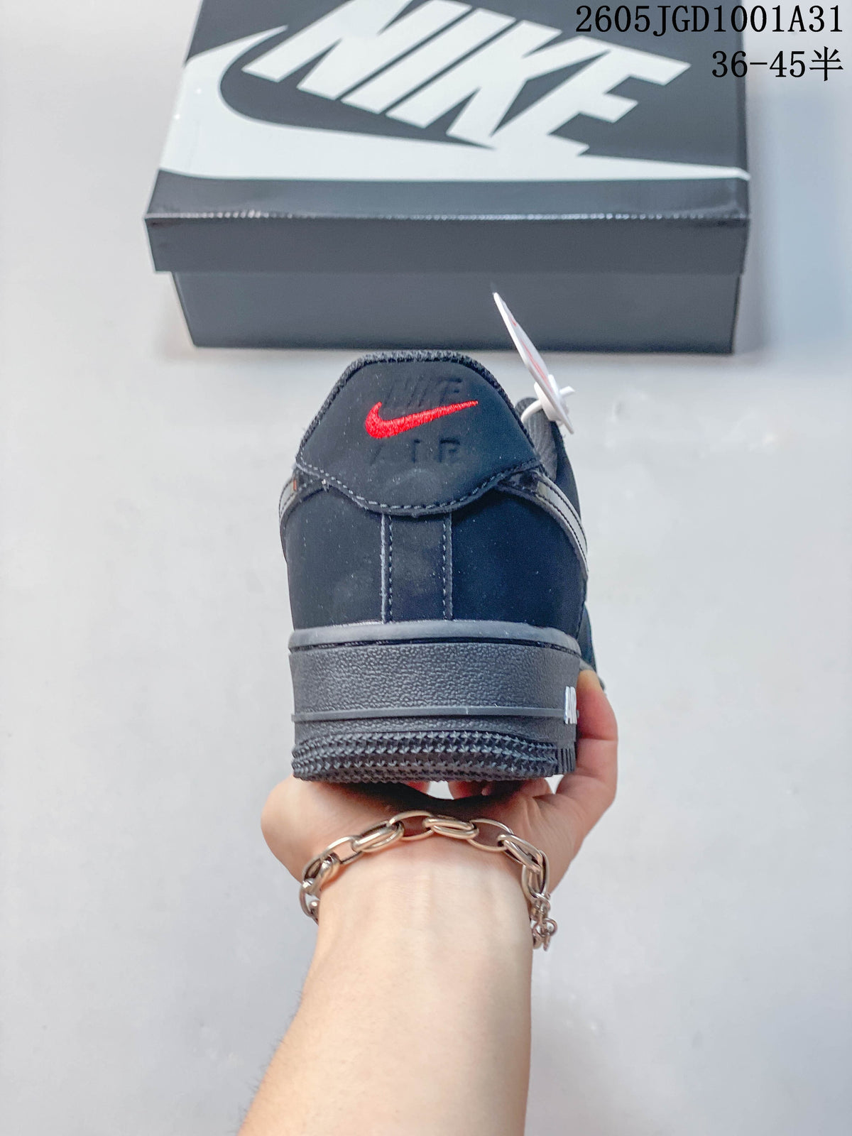 Rear view of a dark navy low-top sneaker with a red heel logo accent