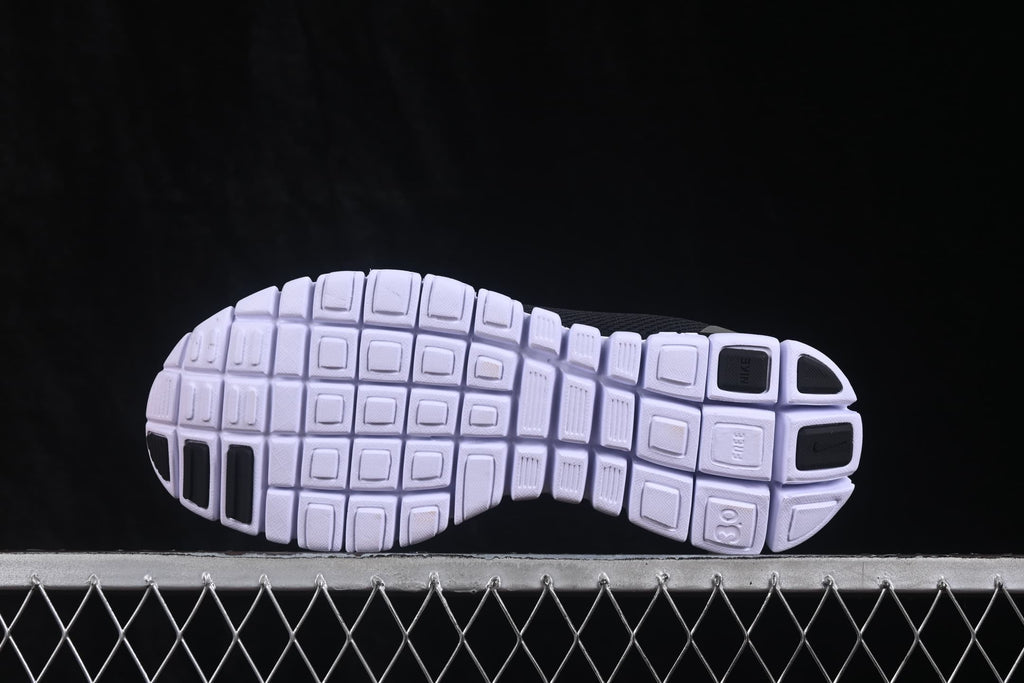 Underside view showing the white segmented outsole pattern and black traction sections.