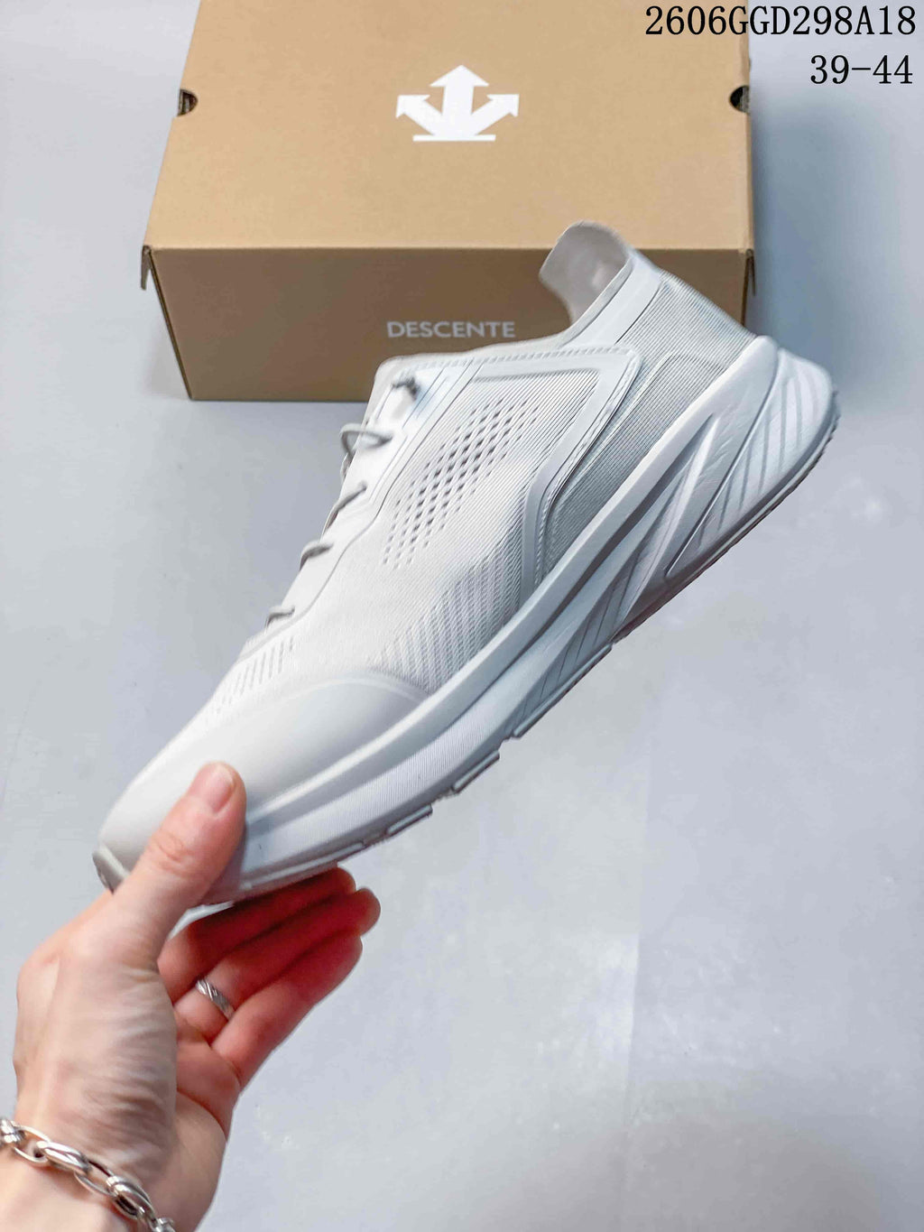 Side profile of the light gray low-top sneaker.