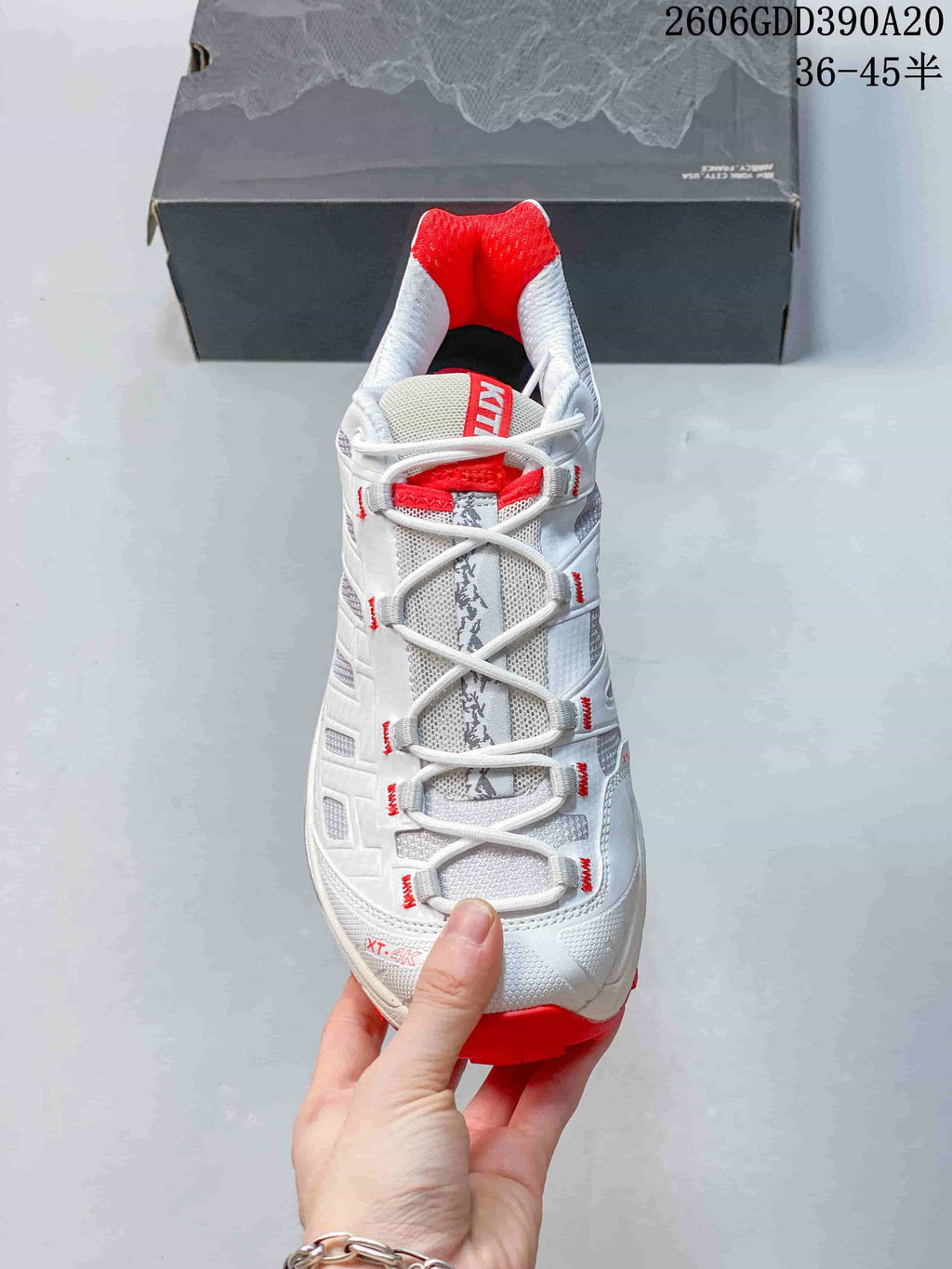 Front view showing the lace-up design, gray detailing, and red lining