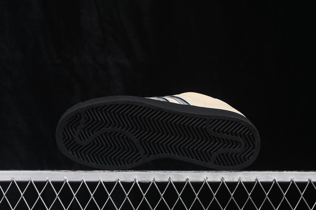 Bottom view showing the black outsole with a herringbone traction pattern and curved grooves.