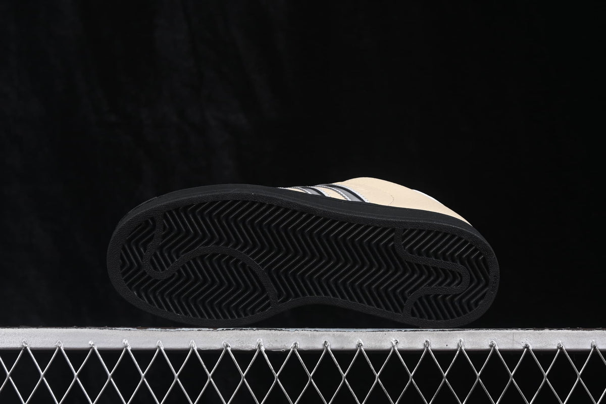 Bottom view showing the black outsole with a herringbone traction pattern and curved grooves.