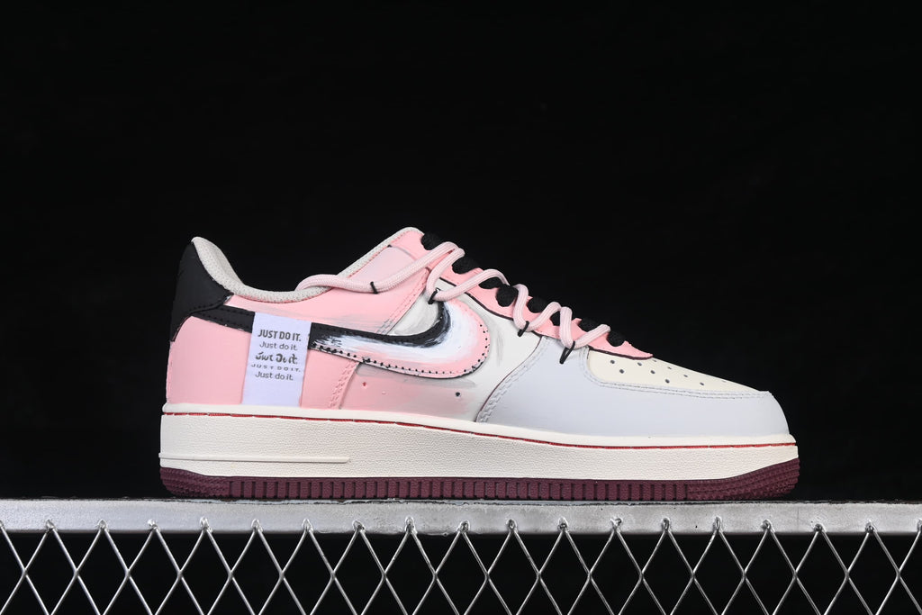Side profile of a white and pink low-top sneaker with graphic details