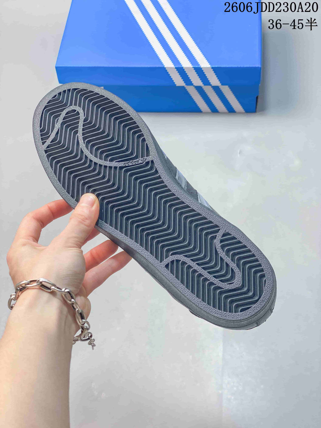 Close-up of the dark gray sneaker outsole with patterned tread