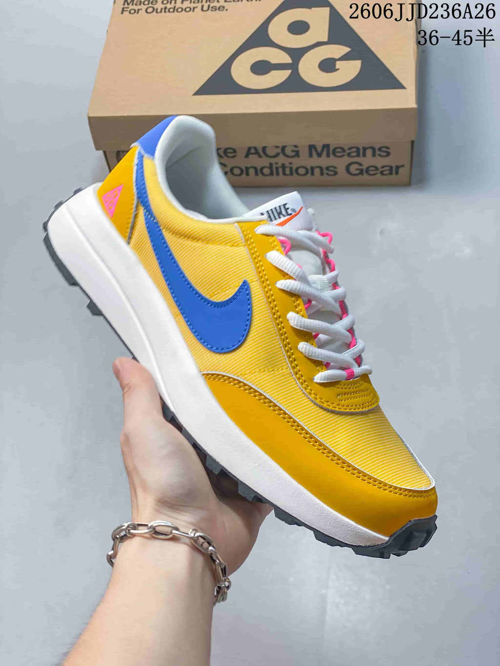 Yellow Nike ACG LDV sneaker shown from the side with a blue Swoosh and dark lugged outsole.