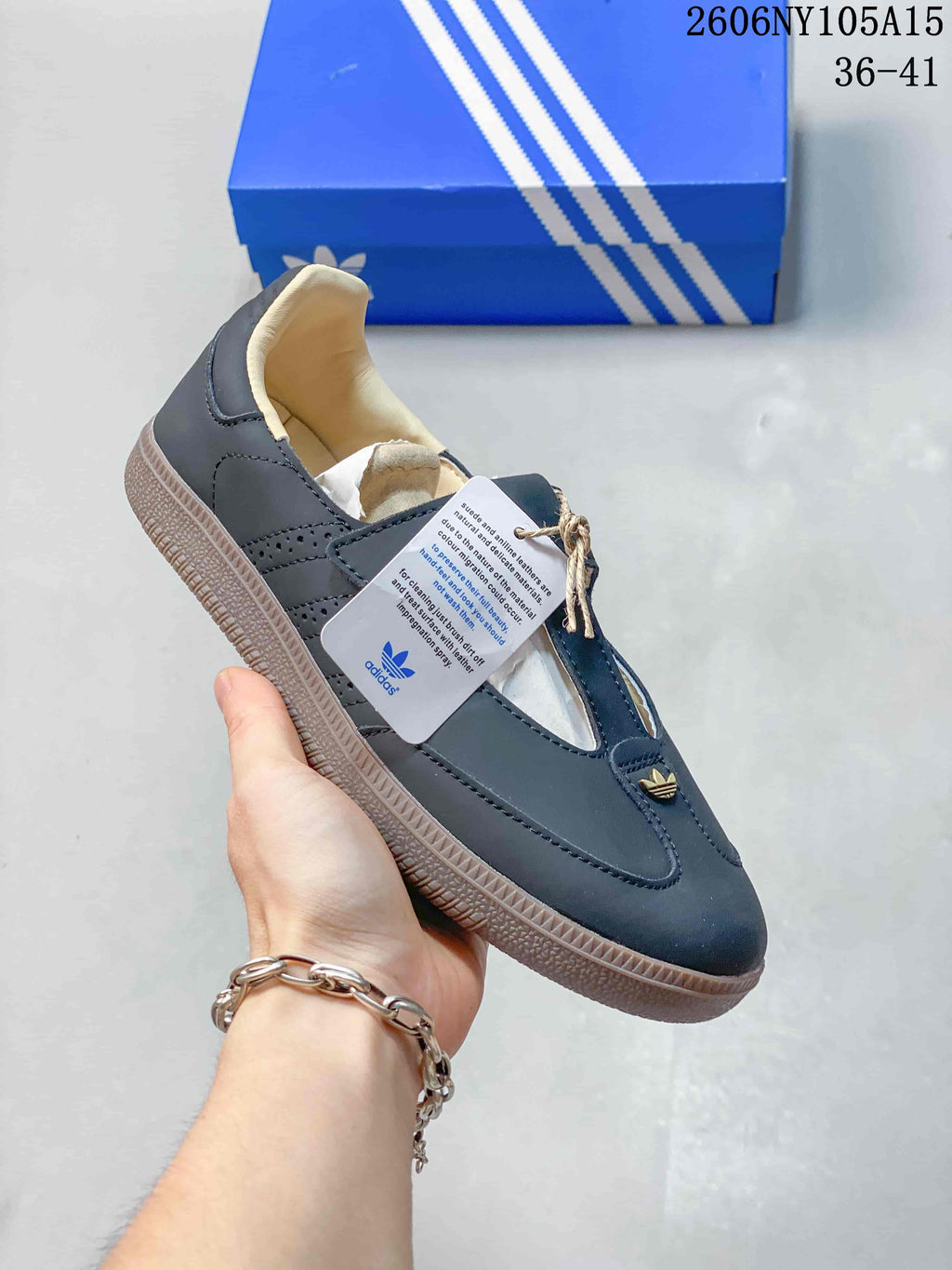 Angled view of the dark blue Samba Jane shoe with its strap, cream-colored lining, and gum-colored sole.