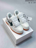 White and black Off-White Out Of Office low-top sneakers with gum-colored soles, shown from the front.