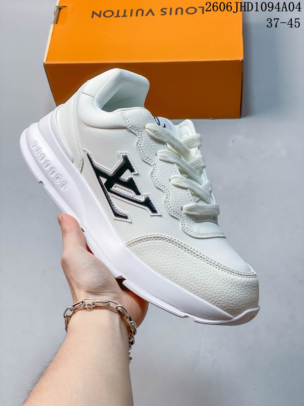 White low-top Louis Vuitton Trainer sneaker with black accents
